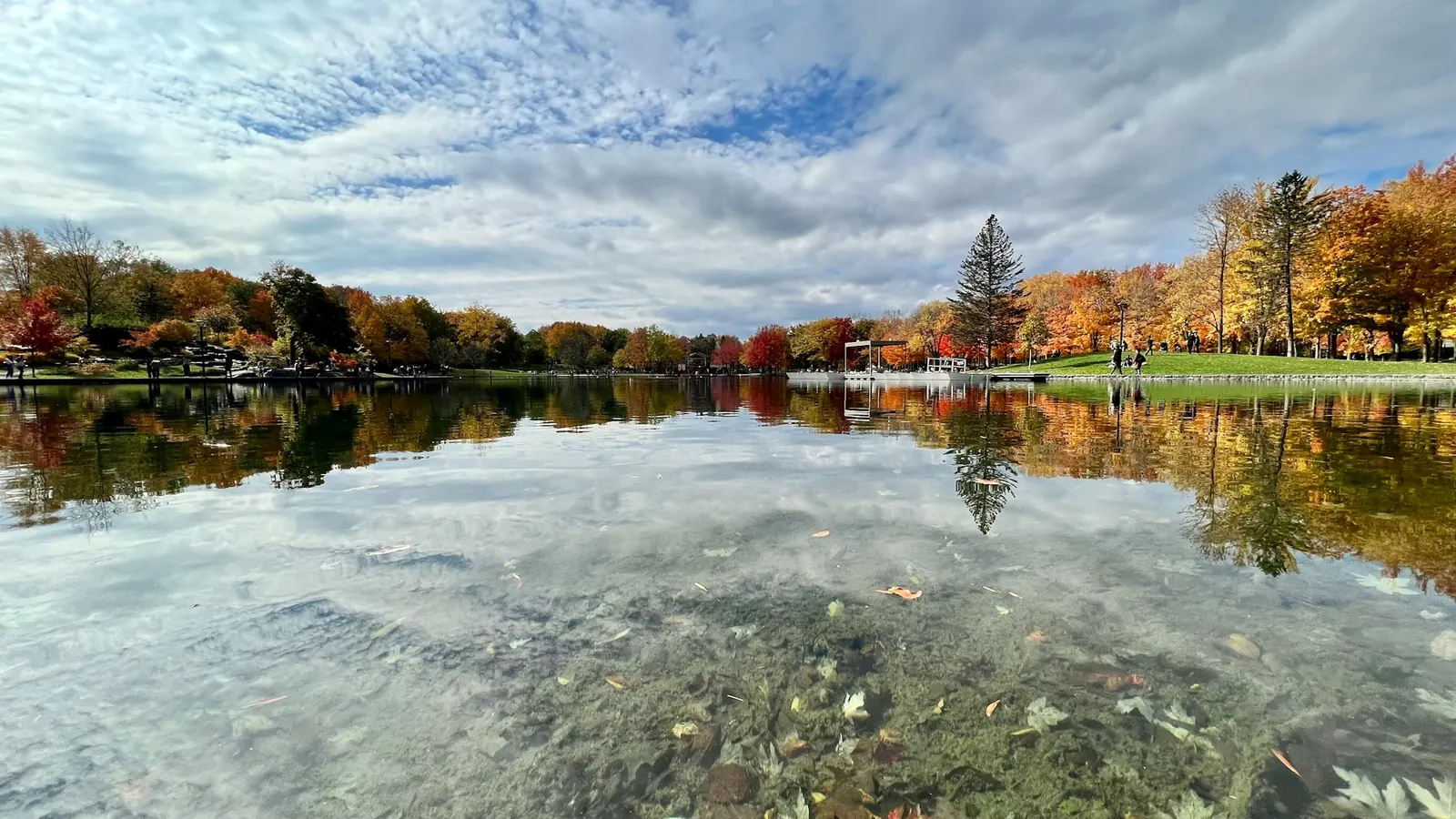 Lake edged by forest in autumn colours in a Quebec resort area